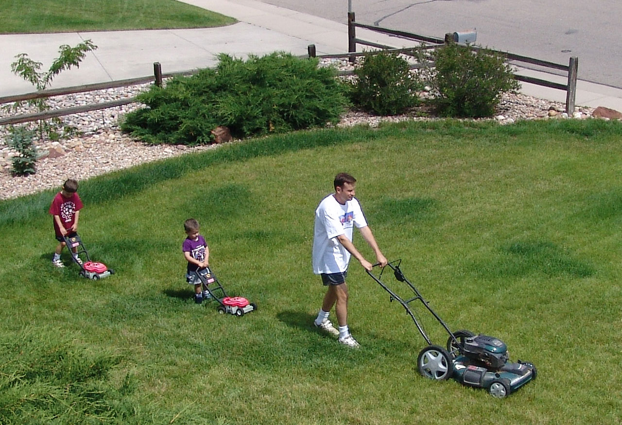boys mowing lawn