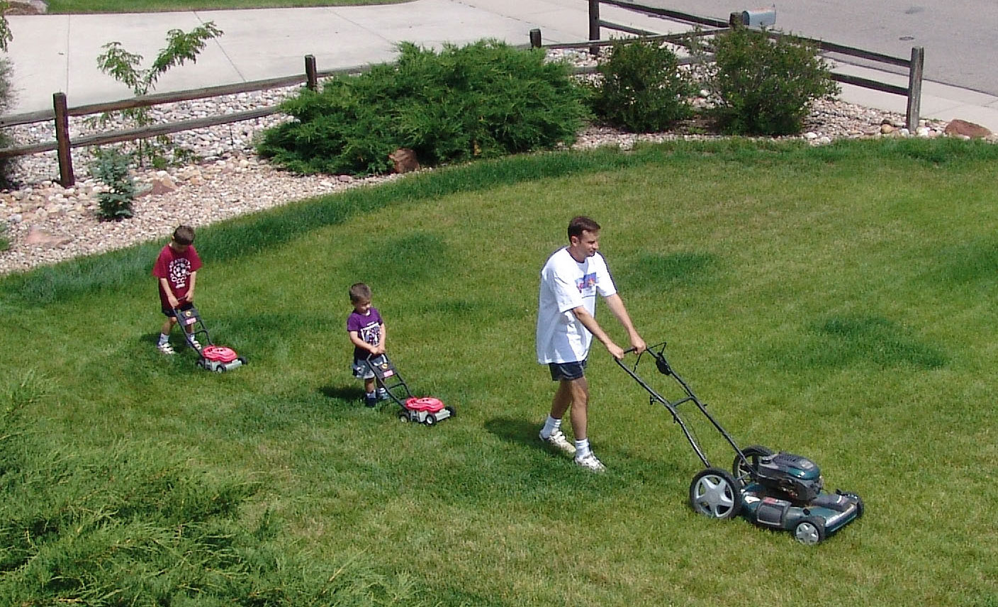 boys mowing lawn closeup